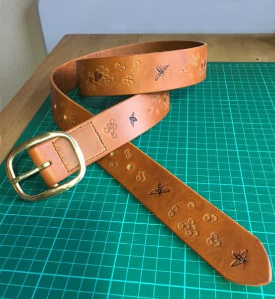 Tan leather belt embossed for a bee keeper