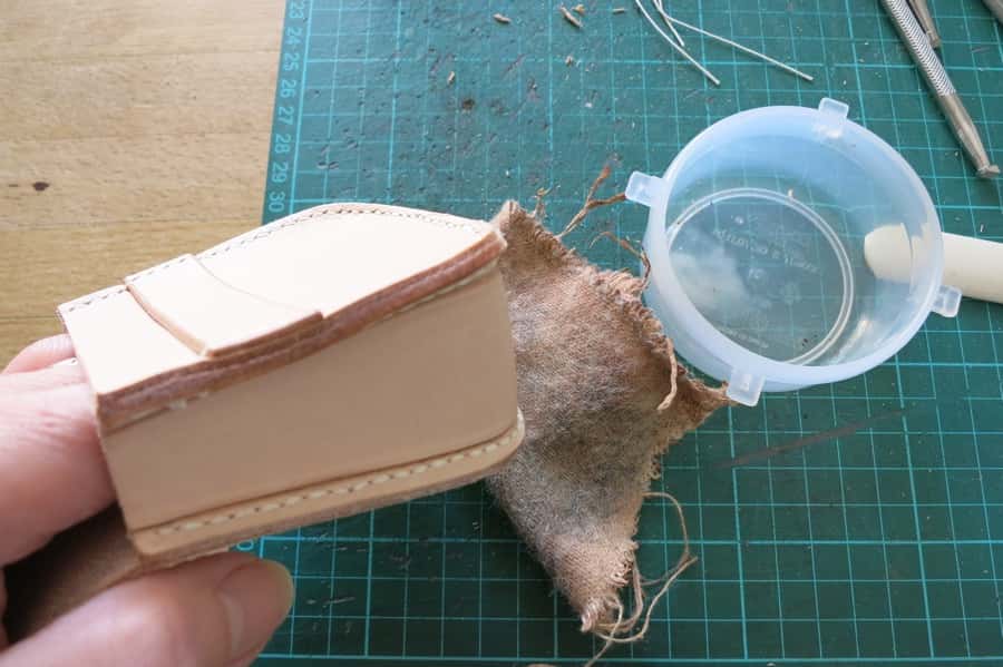 Preparing to burnish a leather pouch