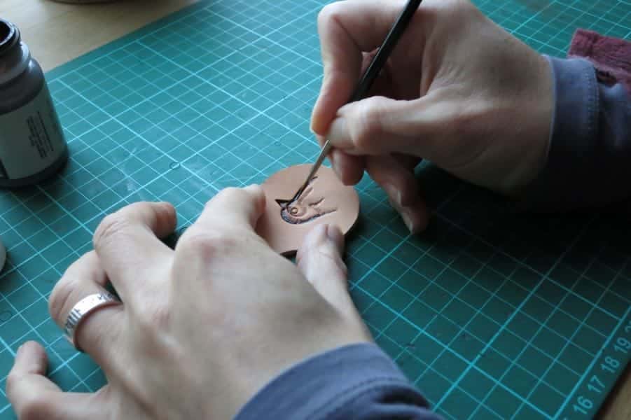Hand painting a motif onto leather
