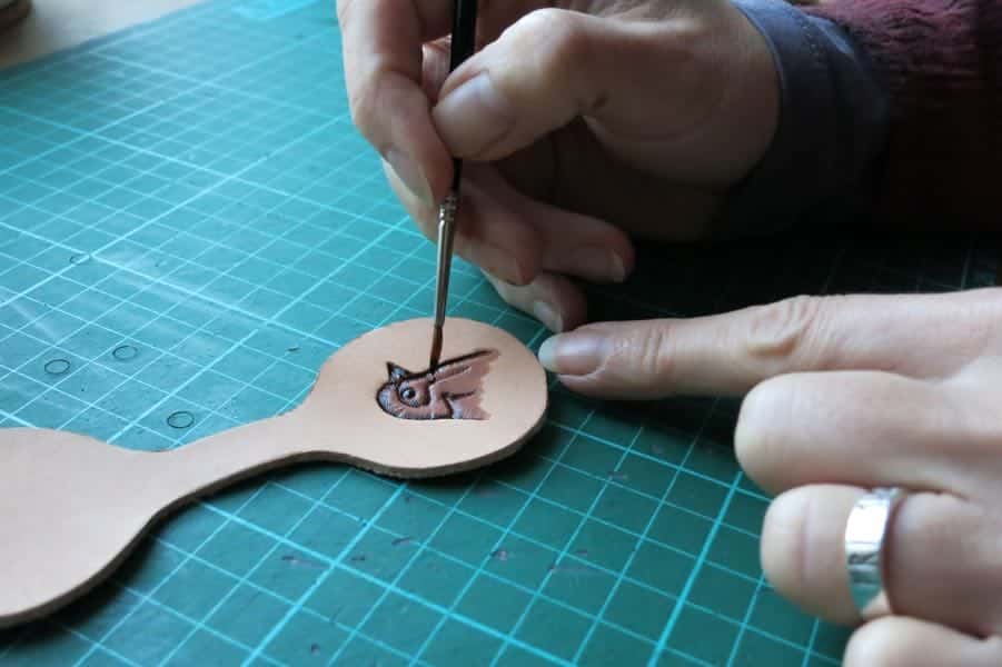 Hand painting a motif onto leather