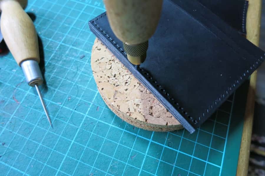 Piercing holes ready for stitching a leather card holder