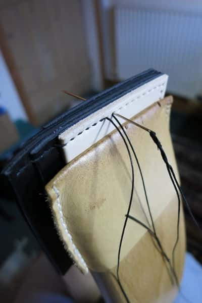 Leather card holder being stitched