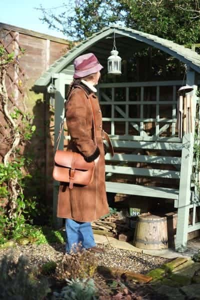 Large leather shoulder bag worn