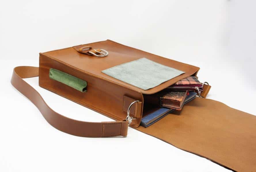 Leather messenger shoulder bag open showing contents