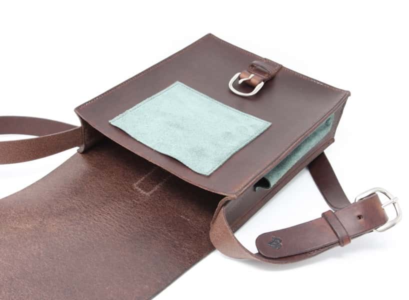 Chocolate coloured artist's sketch bag laying open against a white background