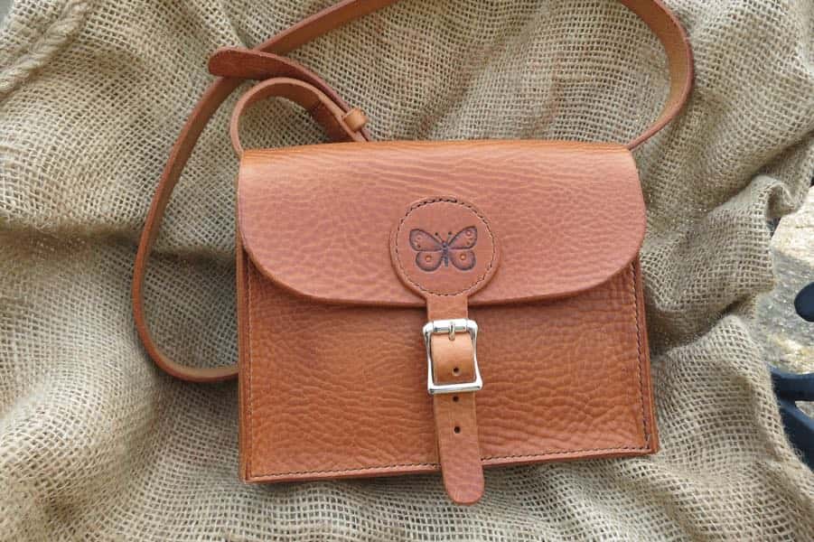 Tan brown medium leather shoulder bag with butterfly motif