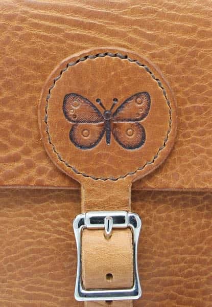 Tan brown medium leather shoulder bag detail of butterfly motif