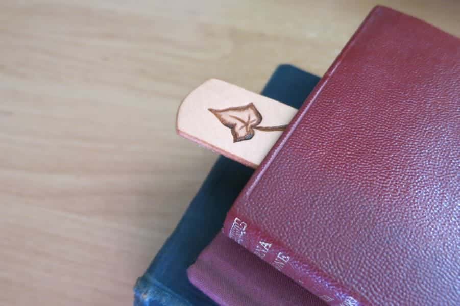 Ivy leaf celtic knot leather bookmark on blue background