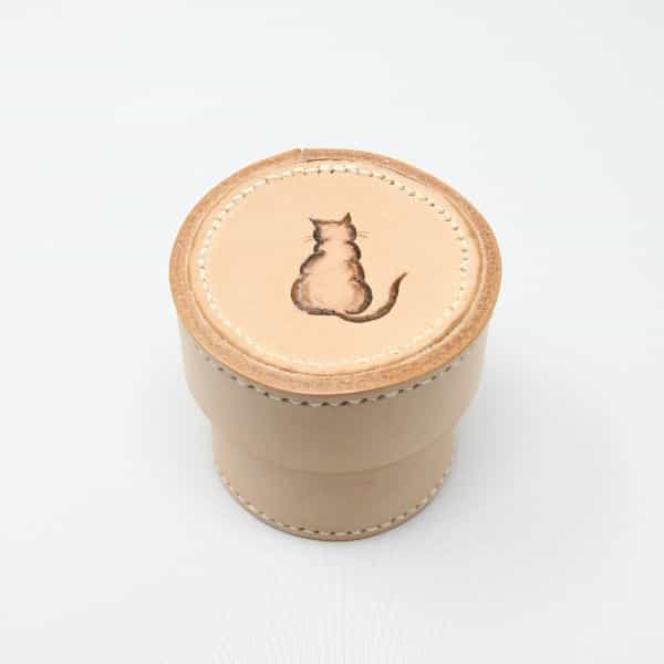 Small round leather box with cat motif
