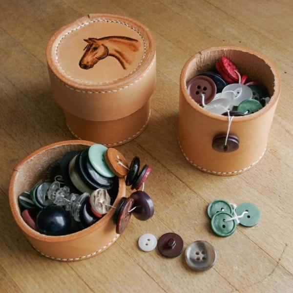 Small round leather box full of buttons