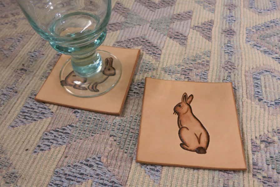 Square leather drinks coasters with rabbit motif