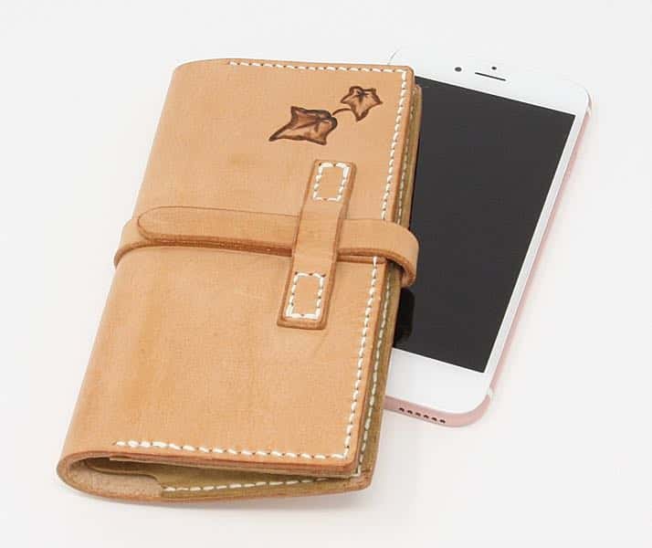 Leather phone case with iPhone on white background