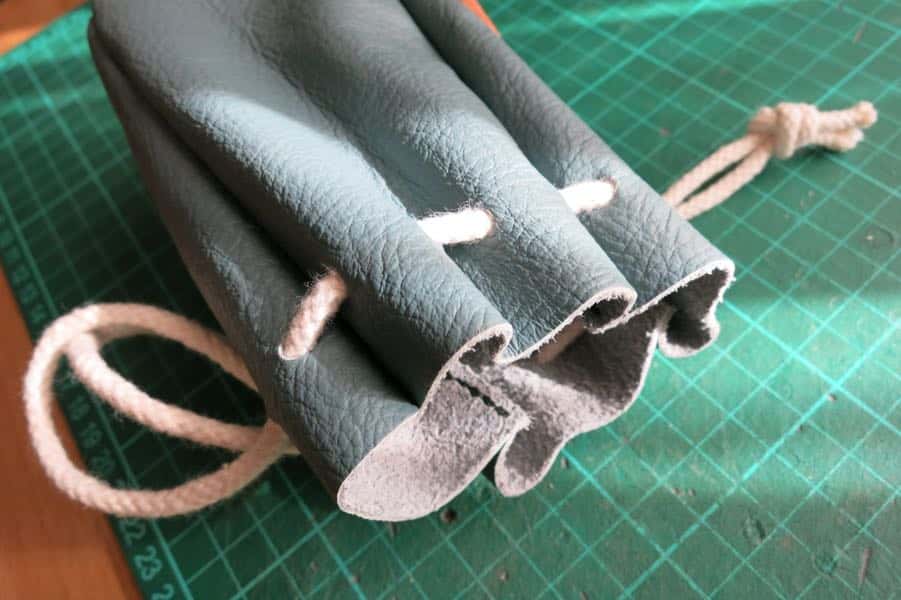 Collar detail of leather drawstring pouch
