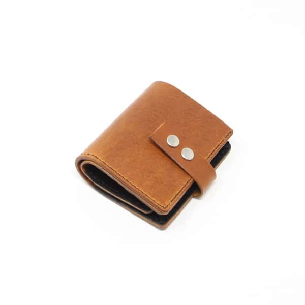 Tan leather jumbo wallet with brown lining. Shown closed