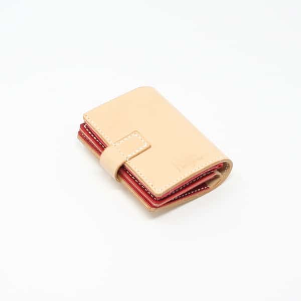 Natural leather jumbo wallet with red leather lining. Shown closed.