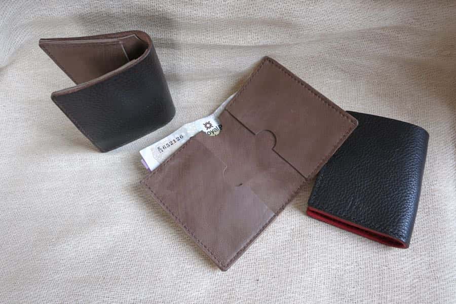 Slim line leather wallet shown folded and open