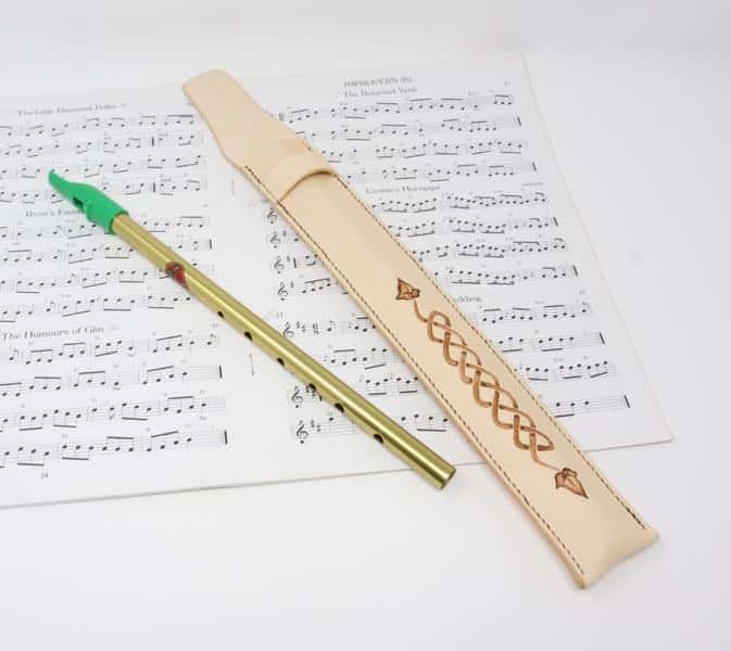 Penny whistle and leather penny whistle case on sheet music